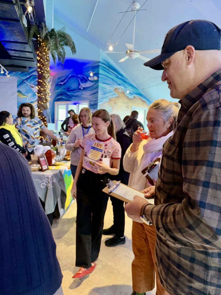 a group of people standing around a table