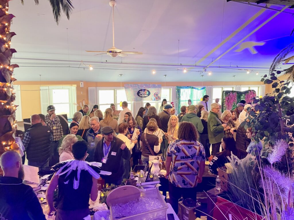 a large group of people standing in a room