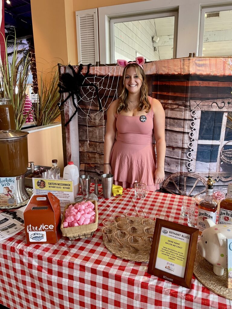 a woman standing in front of a table with a red and white checkered table