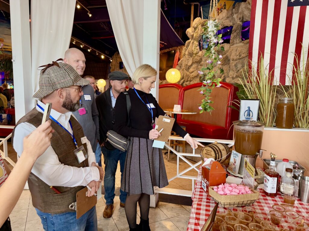 a group of people standing around a table