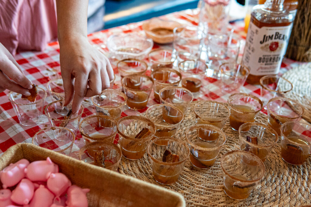 a table topped with lots of glasses filled with liquid