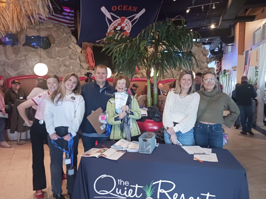 a group of people standing around a table