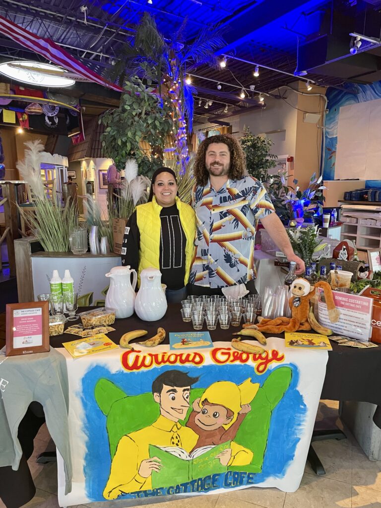 a man and a woman standing behind a table