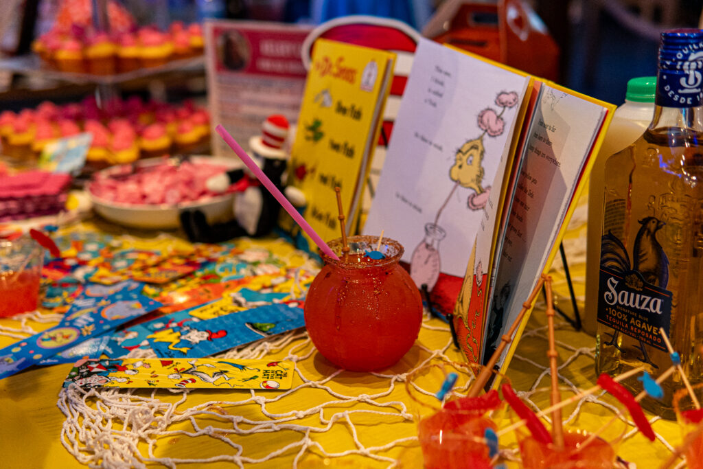 a table topped with lots of cupcakes and drinks