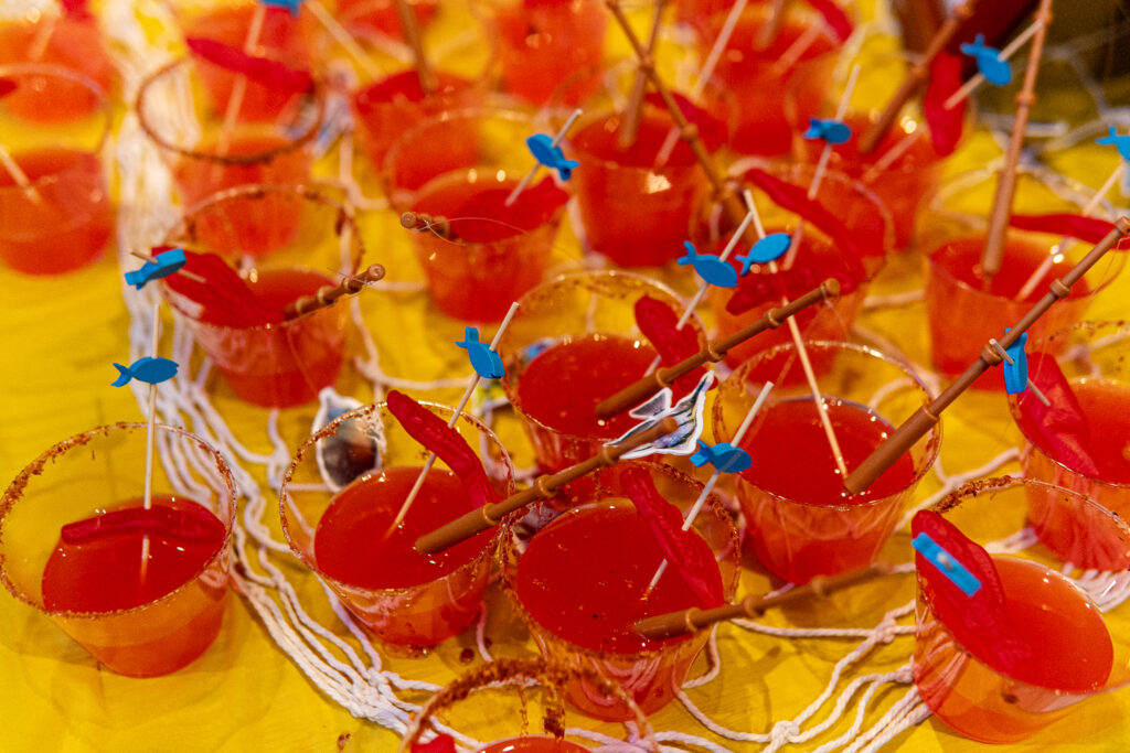 a table topped with lots of small cups filled with food