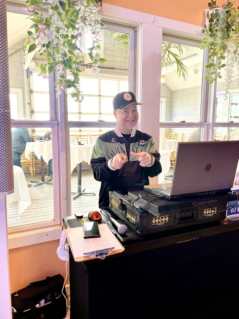 a man standing in front of a laptop computer