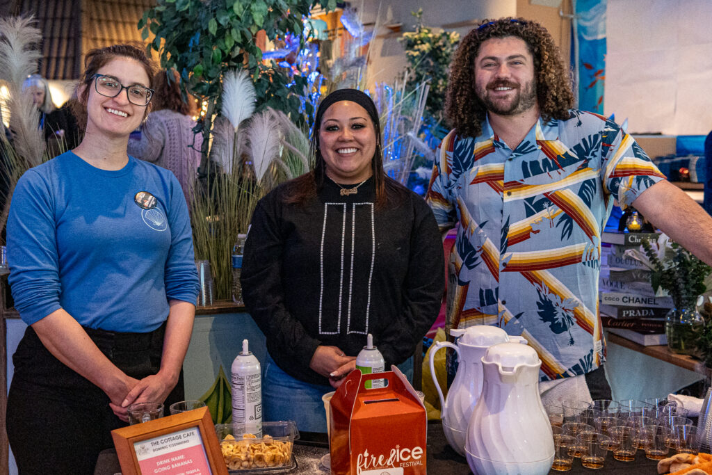 a group of people standing around a table