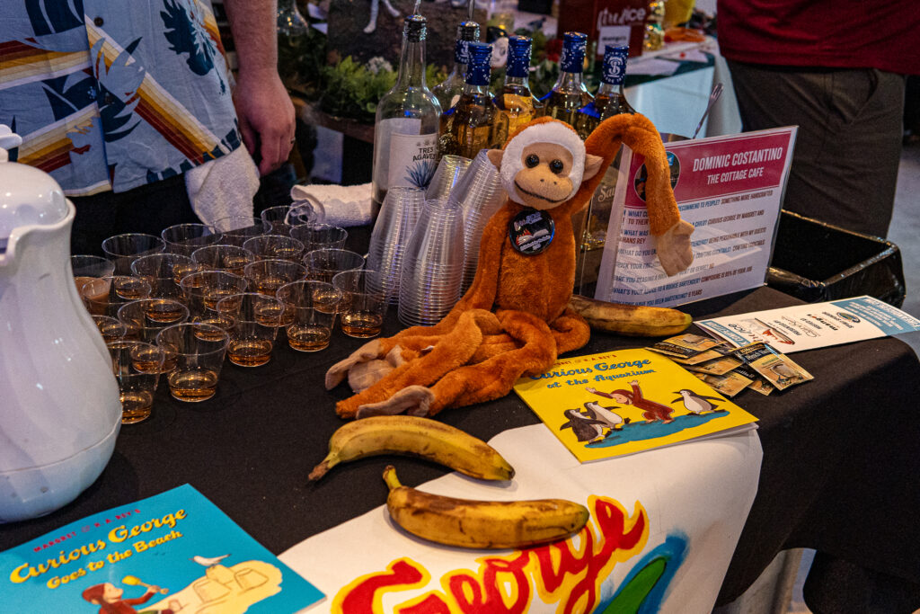 a table topped with a banana and a monkey
