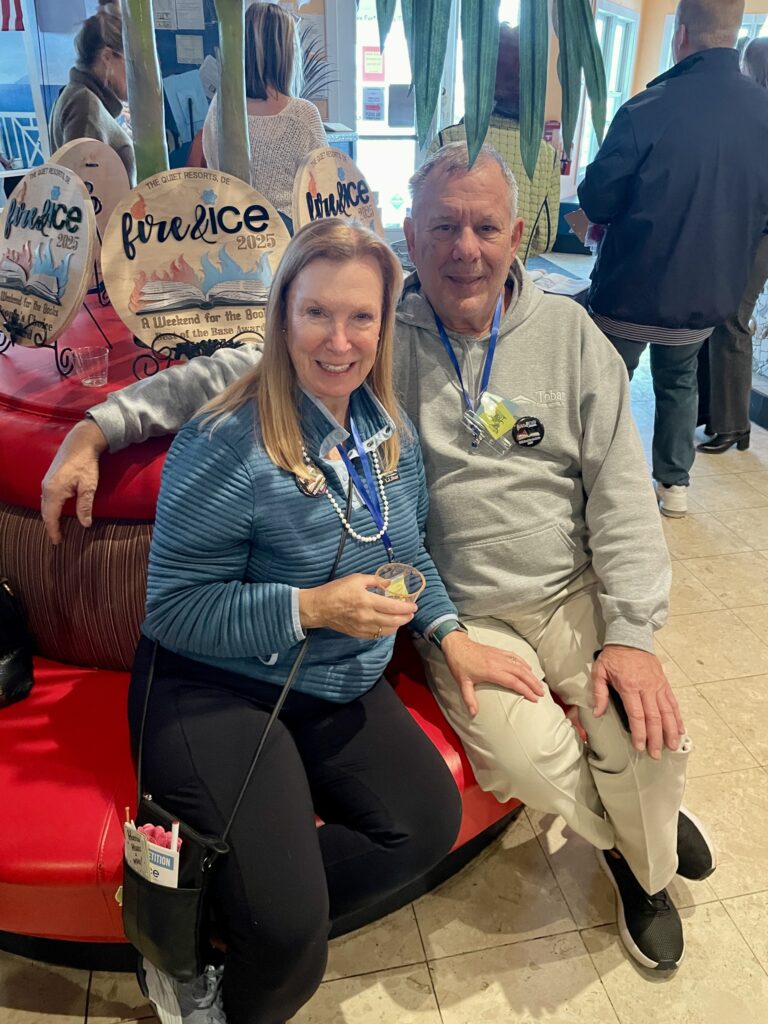 a man and a woman sitting on top of a red chair