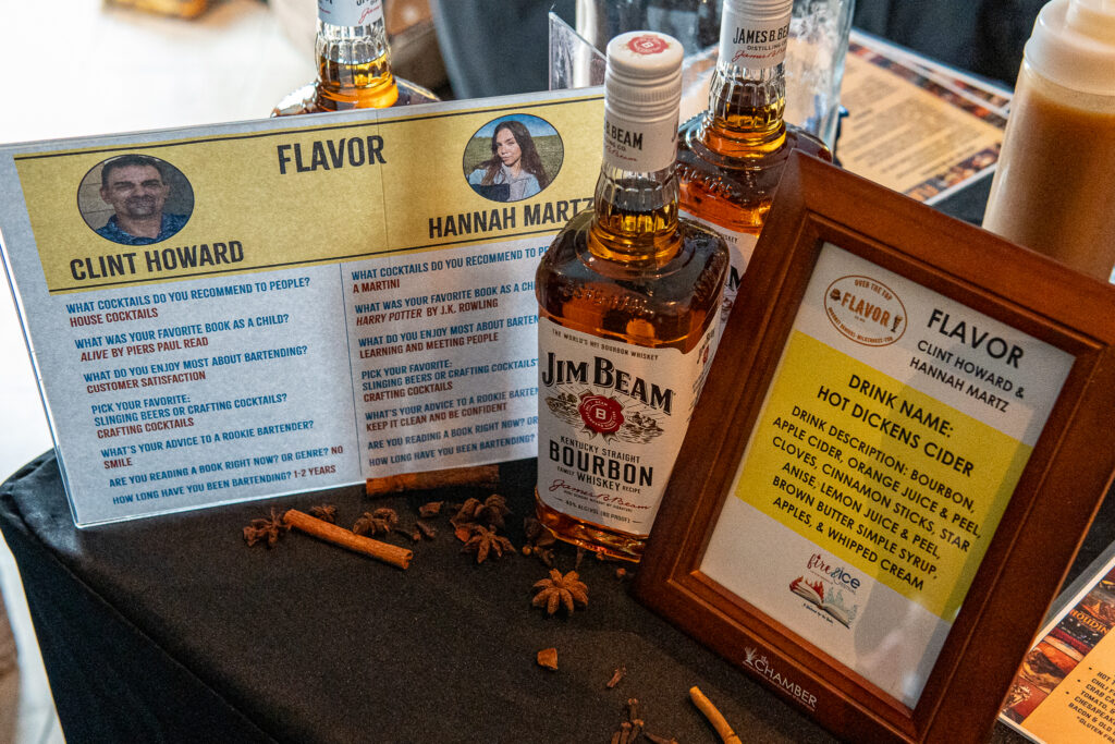 a picture frame sitting on top of a table next to bottles of liquor
