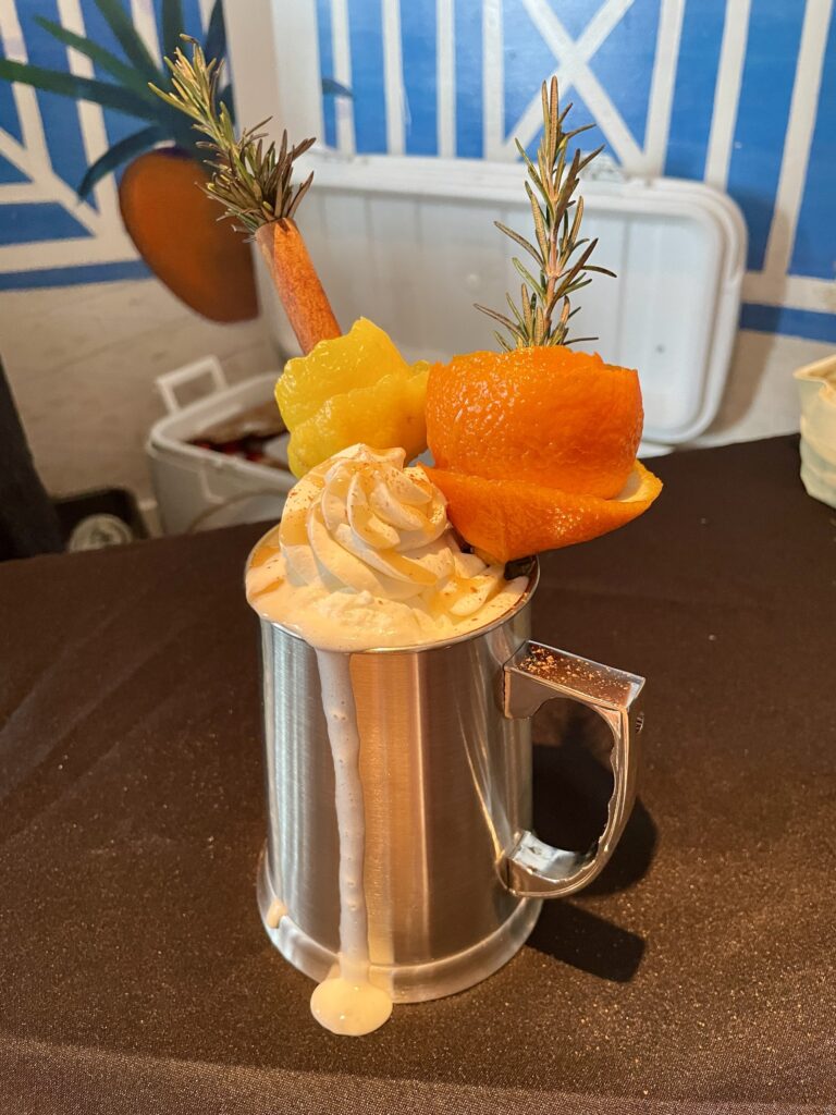 a cup of coffee with whipped cream and fruit on top