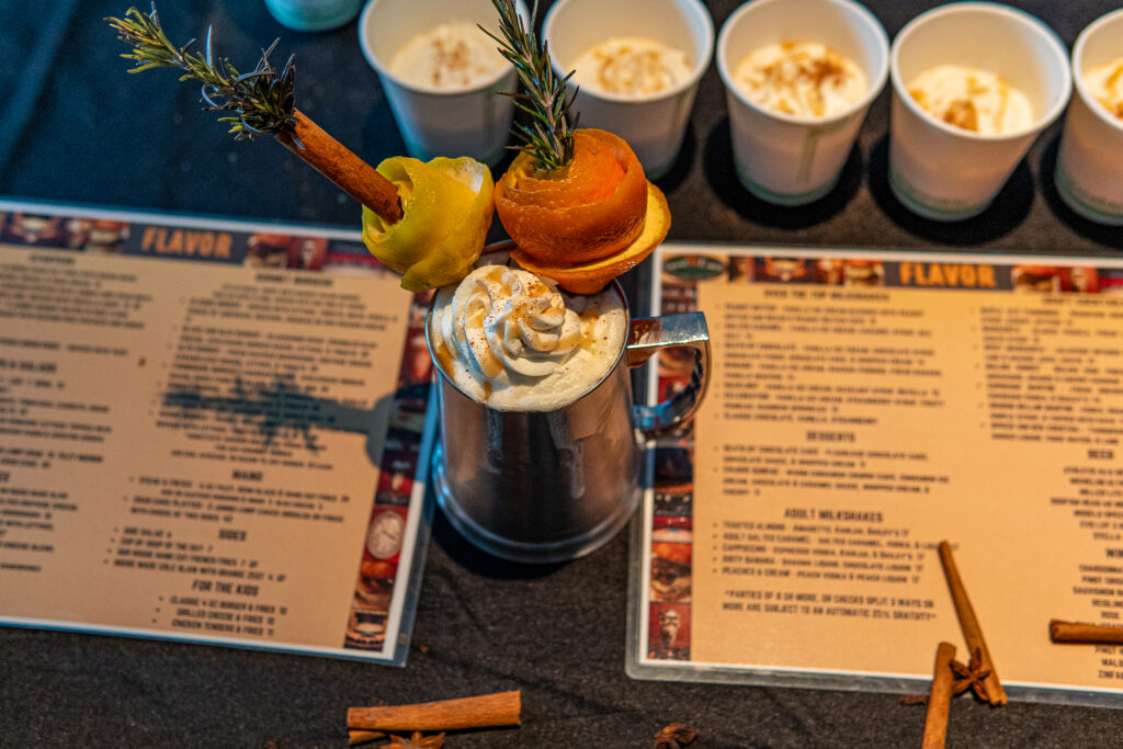 a table with a menu and cups of food on it