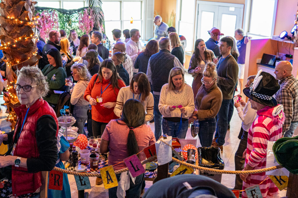 a group of people standing around a christmas tree