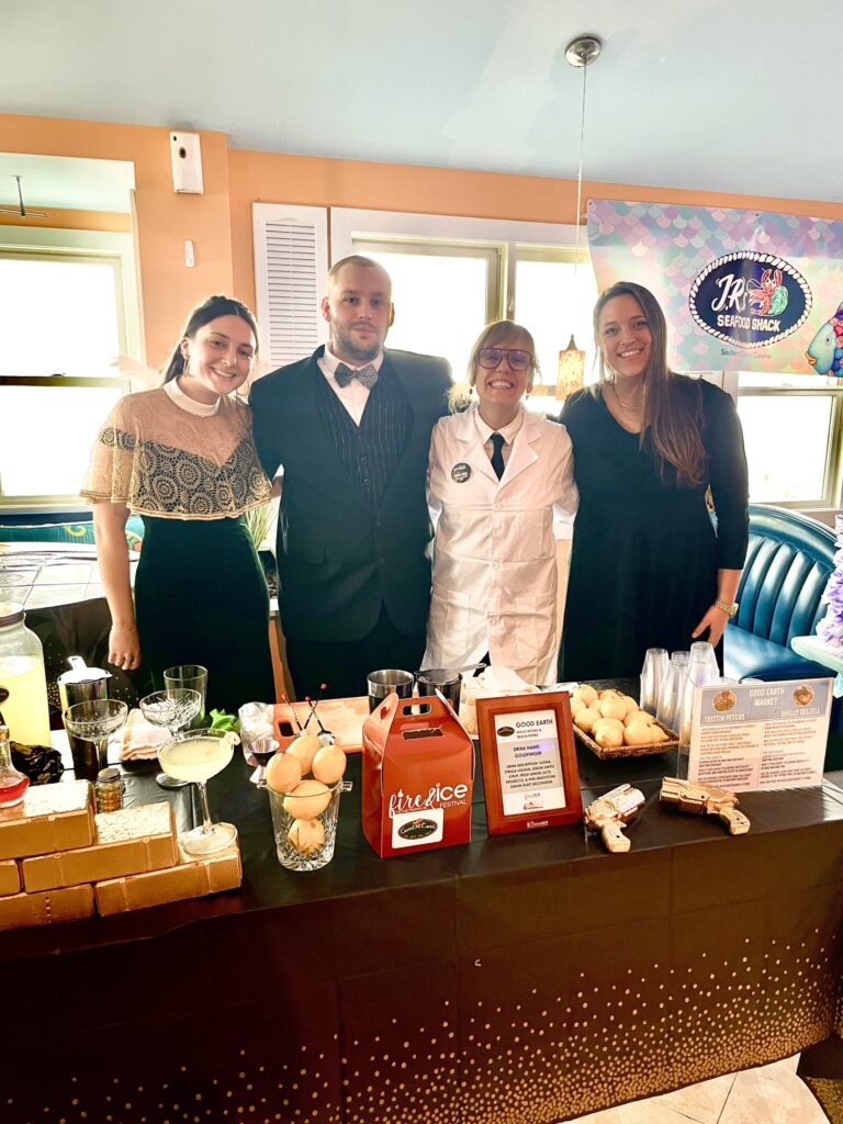 a group of people standing in front of a table