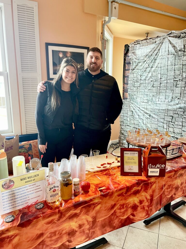 a man and a woman standing in front of a table