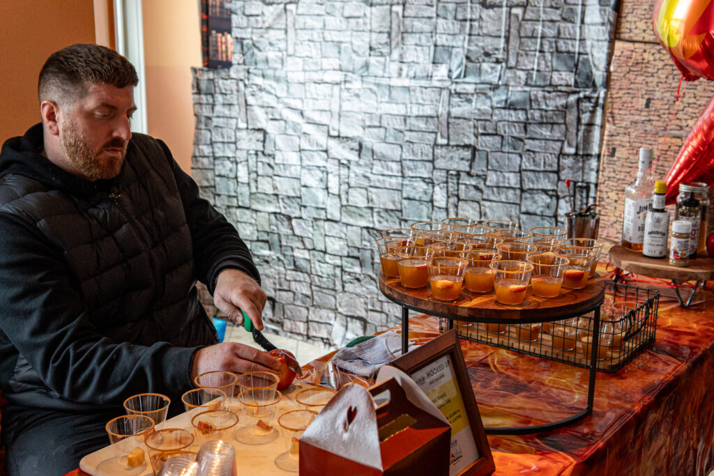 a man sitting at a table filled with drinks