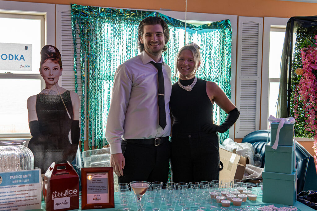 a man and a woman standing in front of a table