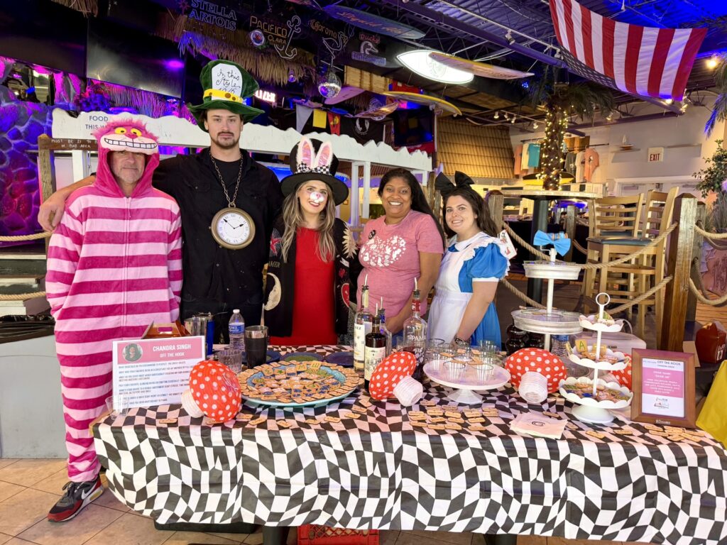 a group of people standing in front of a table