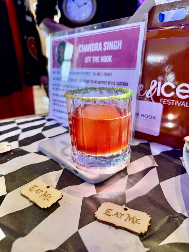a table topped with a glass filled with liquid