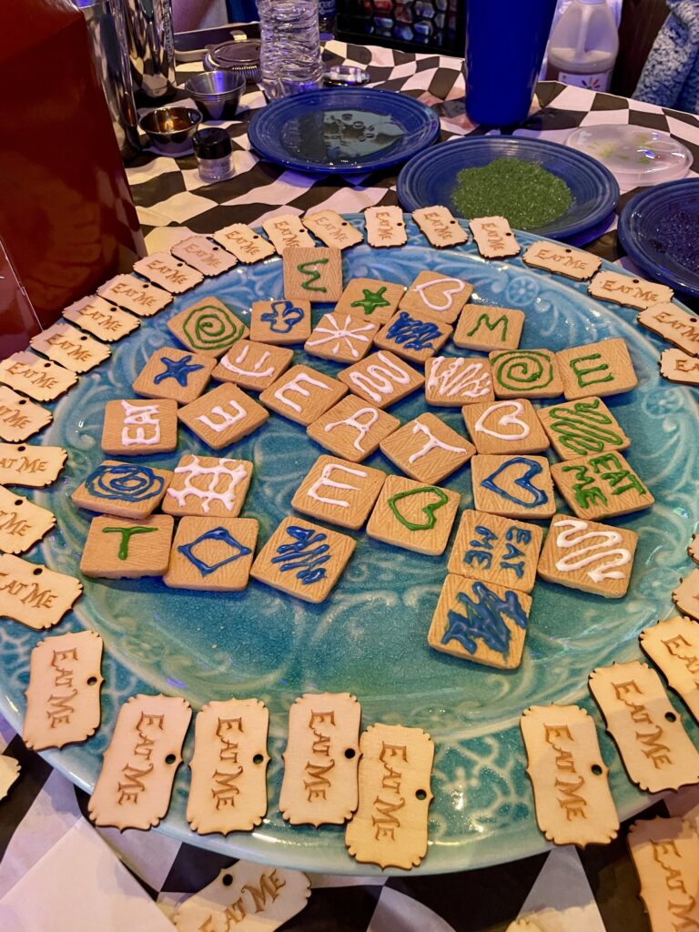 a blue plate topped with lots of cookies on top of a table