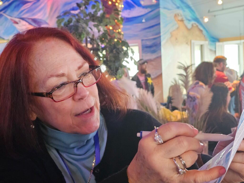 a woman holding a piece of paper in her hands