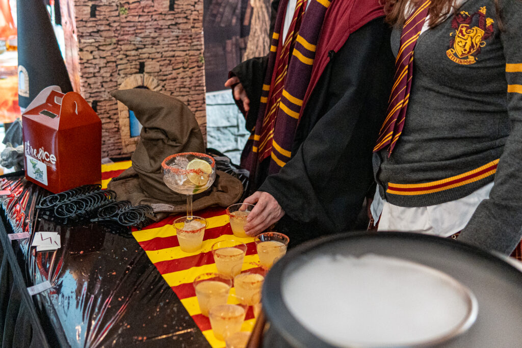 a couple of people that are standing in front of a table