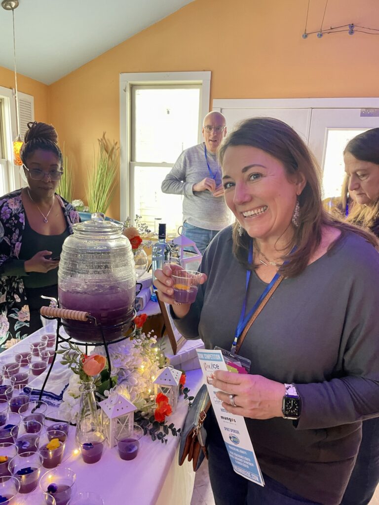 a group of people standing around a table