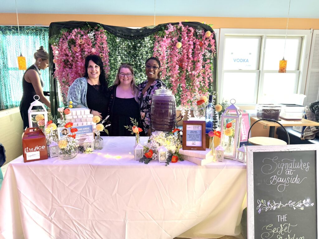 a group of people standing around a table