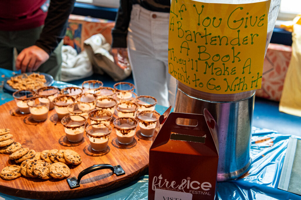 a table topped with lots of cookies next to a bottle of wine