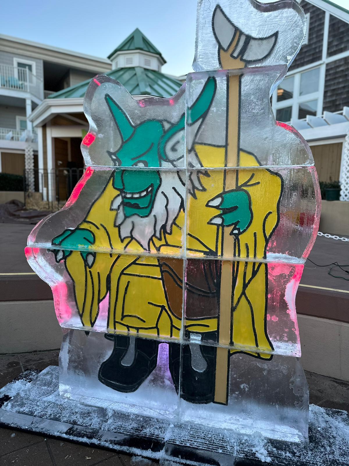 an ice sculpture of a man holding a giant hammer