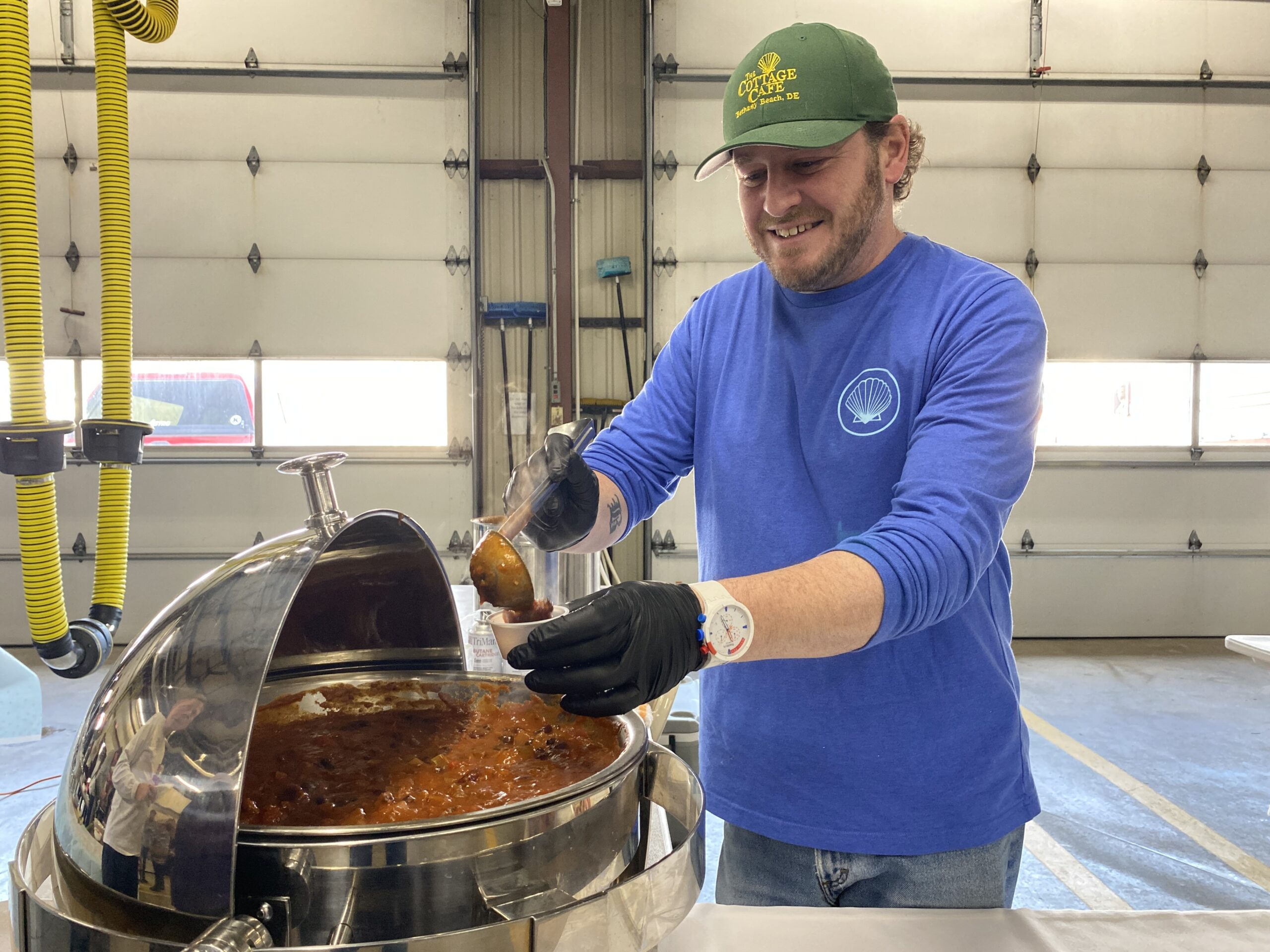 a man in a blue shirt and a green hat