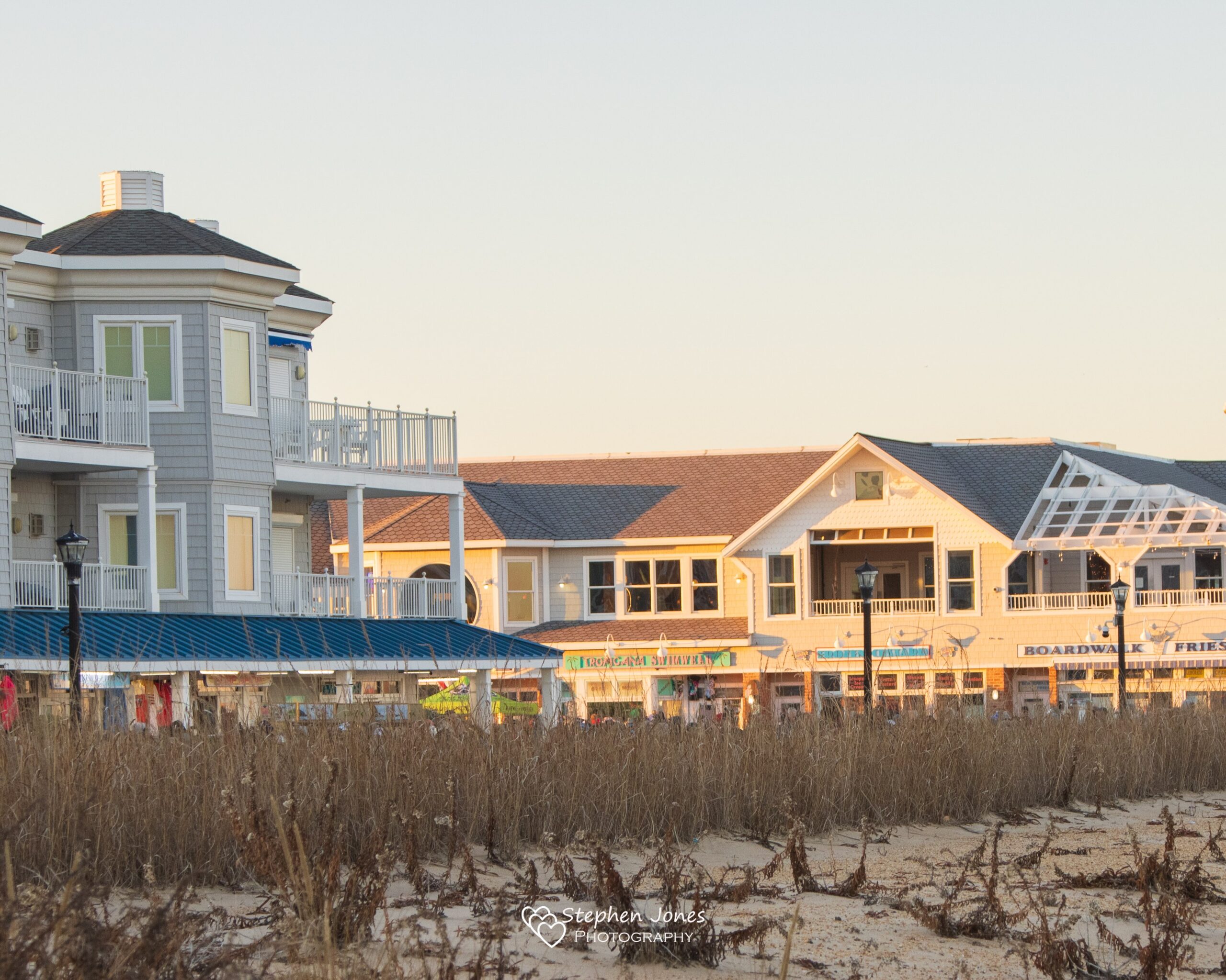 a row of houses on a beach near the ocean