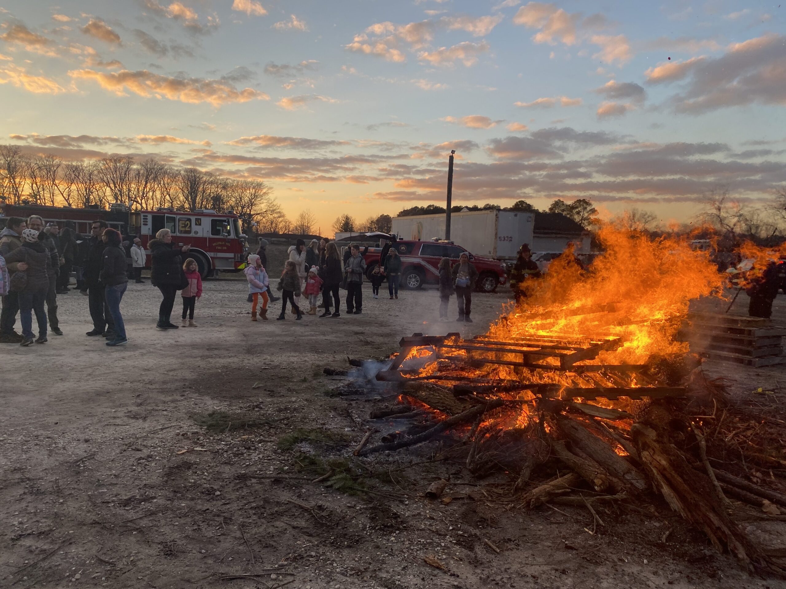 a group of people standing around a fire