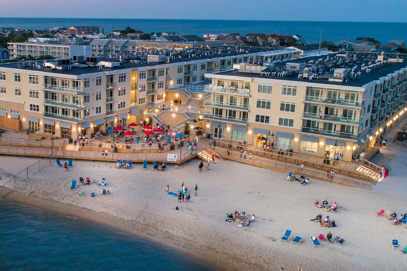 an aerial view of a beach with a hotel in the background
