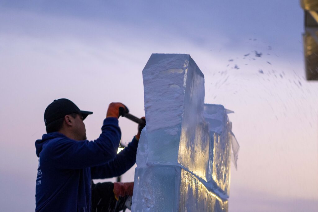 a man is working on an ice sculpture