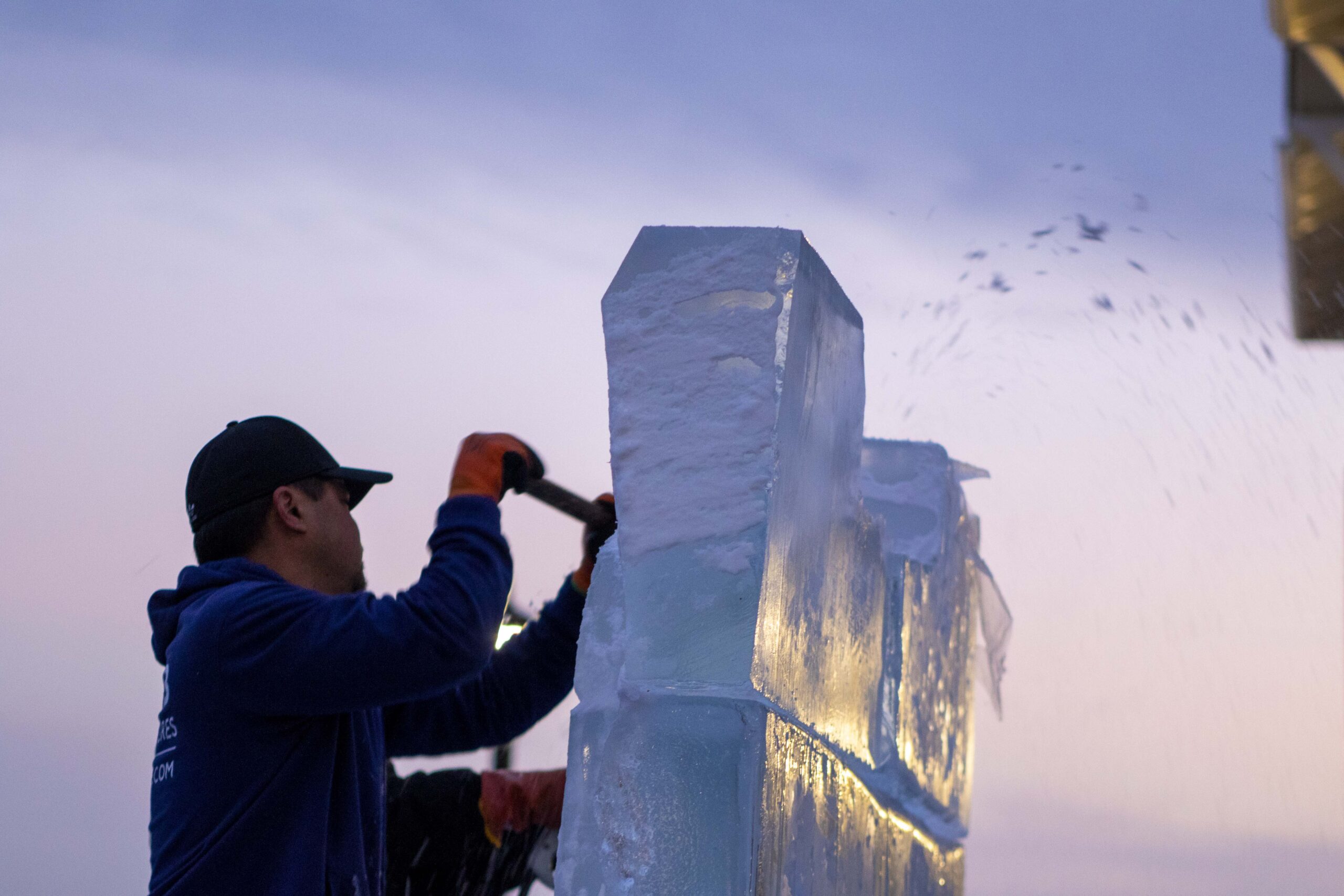 a man is working on an ice sculpture