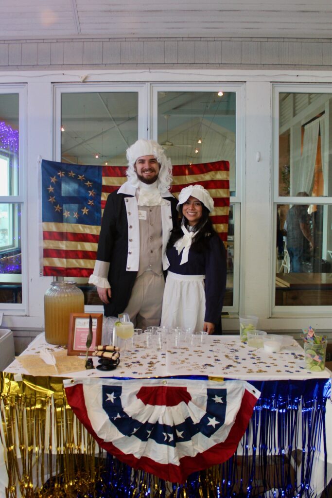 a man and a woman standing in front of a table