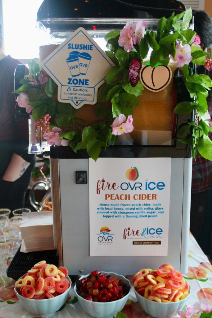 a table topped with bowls of food next to a sign