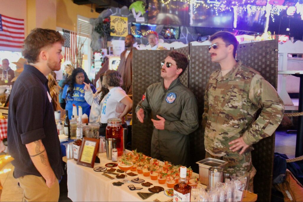 a group of people standing around a table