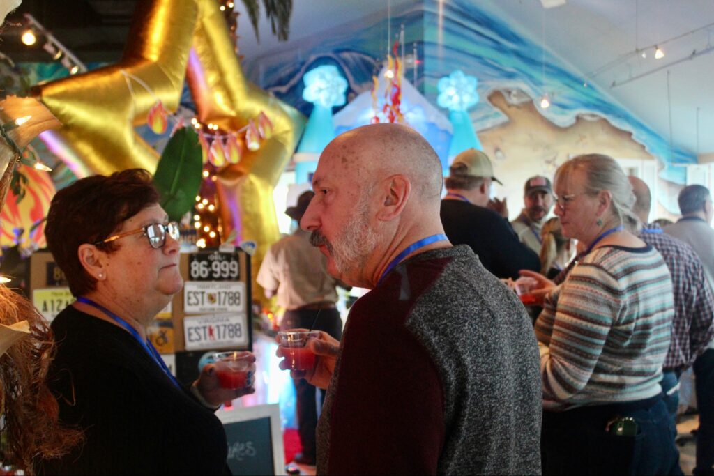 a group of people standing around a bar
