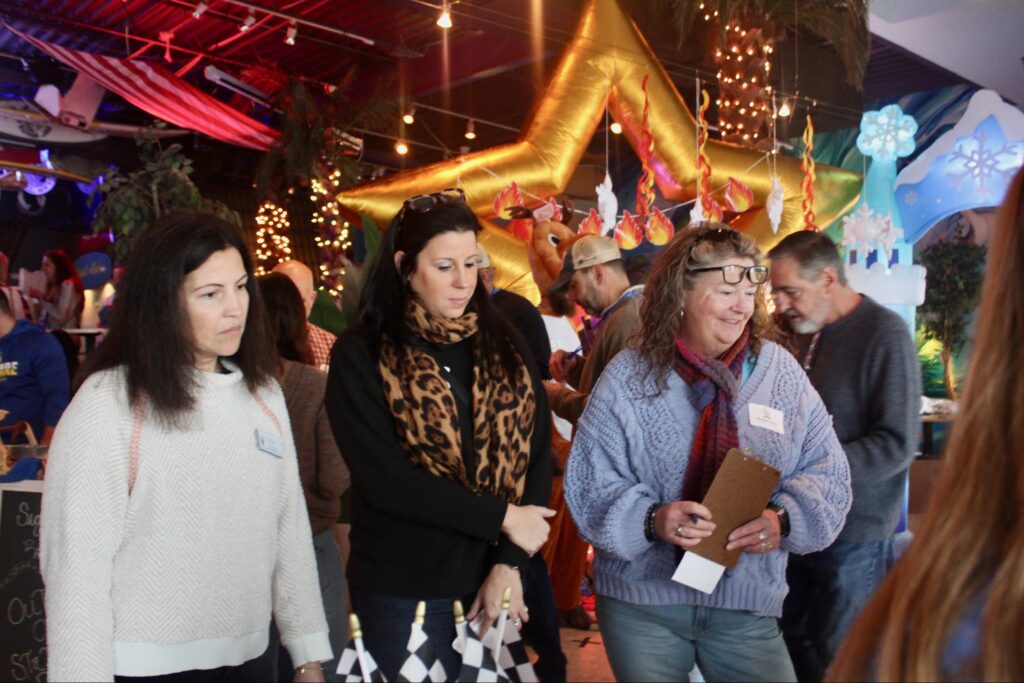 a group of people standing around each other