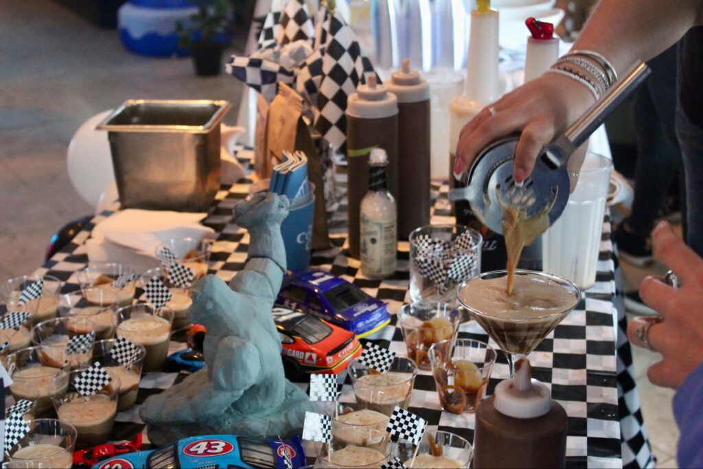 a person pouring a drink into a glass