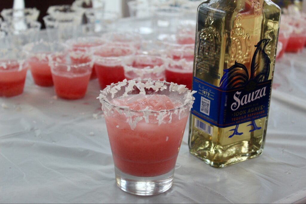 a table topped with glasses and a bottle of alcohol