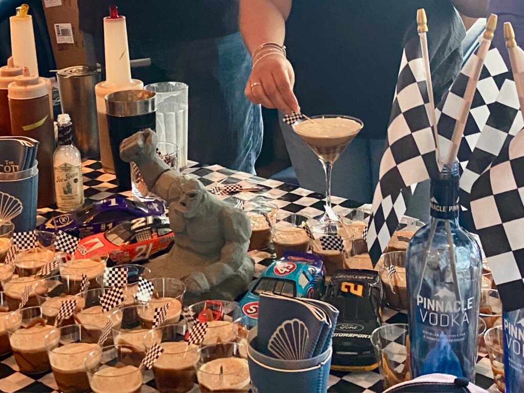 a table topped with lots of cups filled with liquid