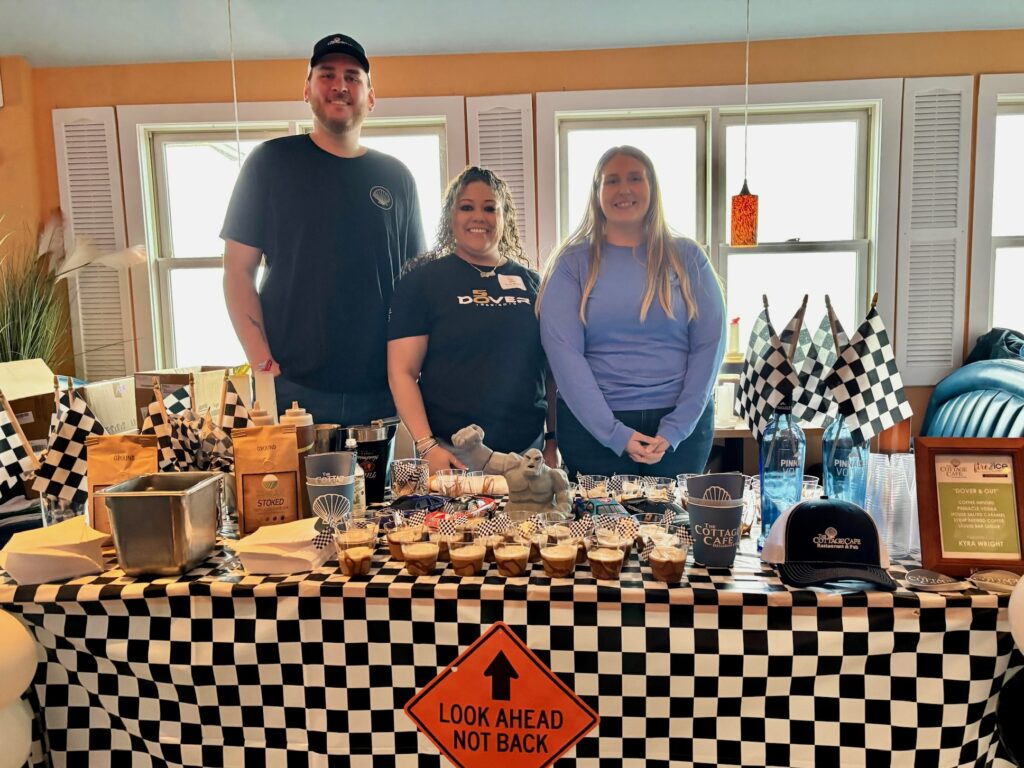 a group of people standing in front of a table