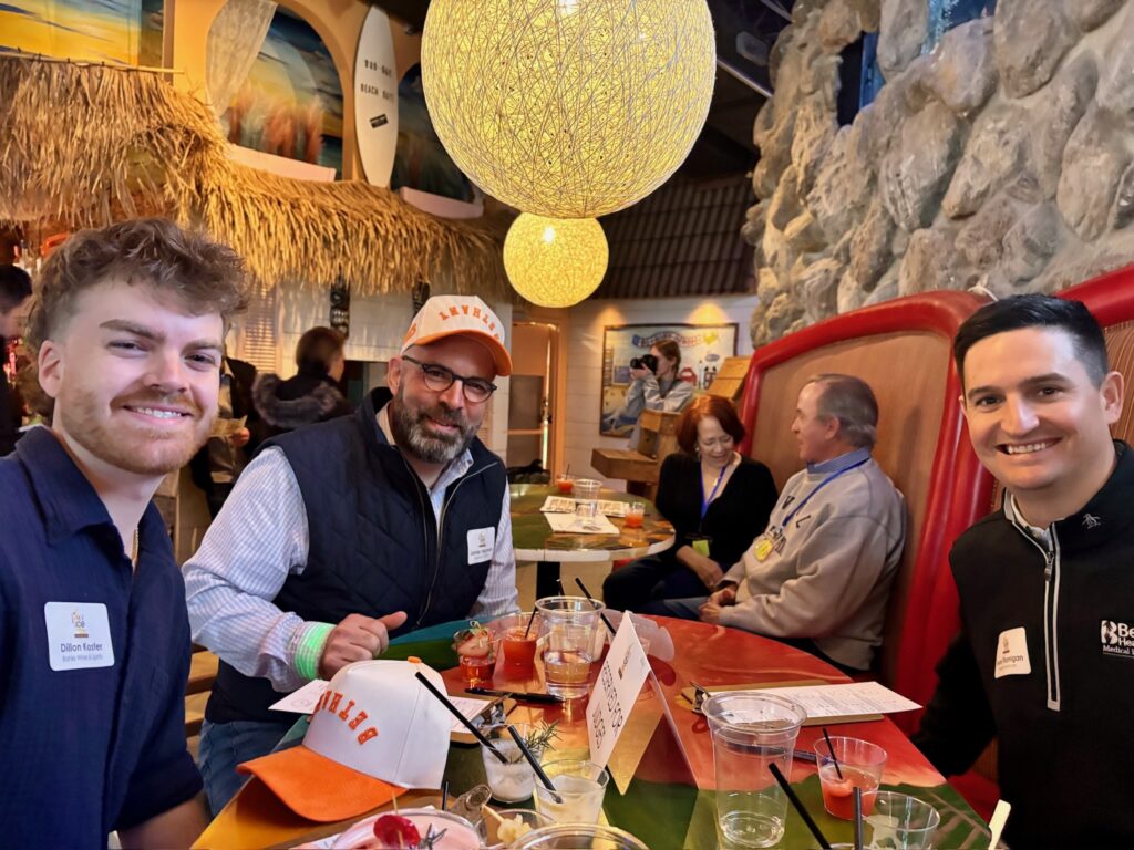 a group of people sitting at a table with food