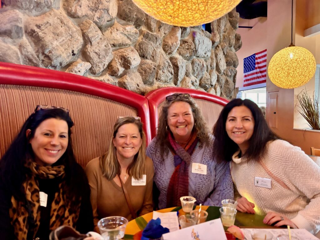 a group of women sitting at a table in a restaurant