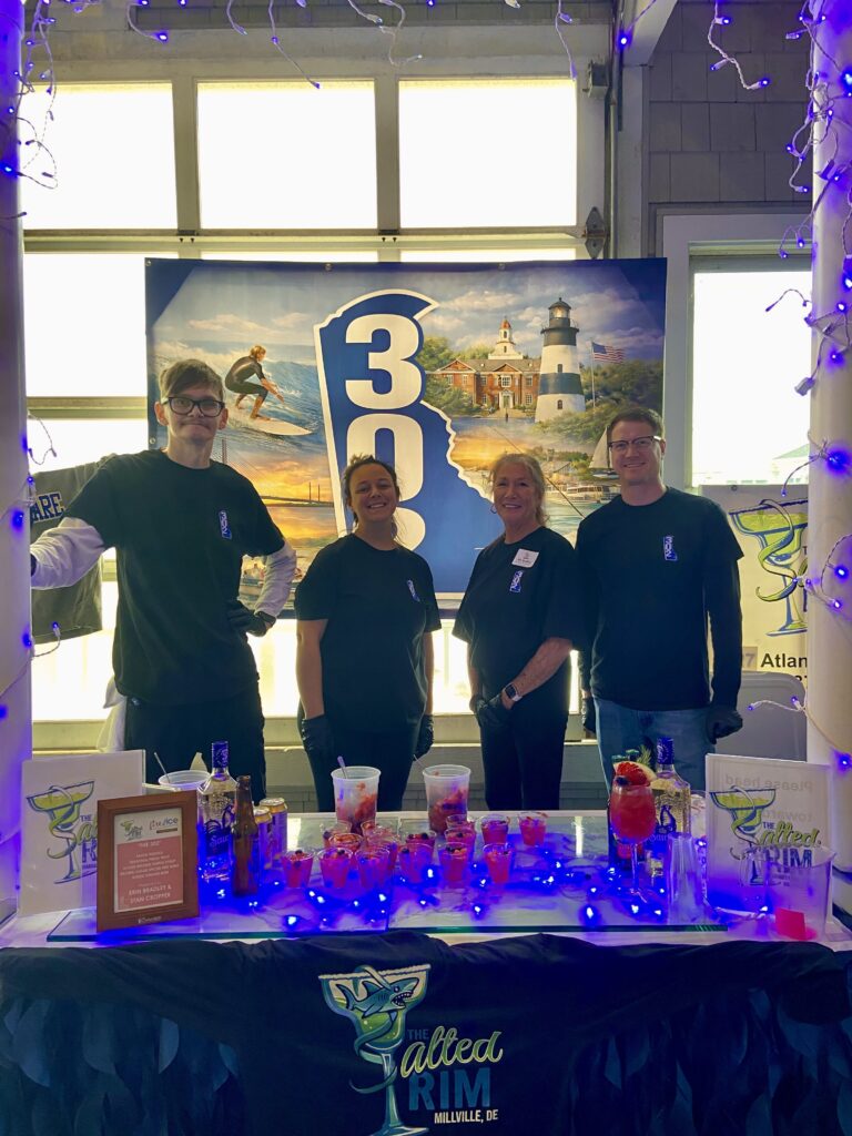 a group of people standing in front of a table