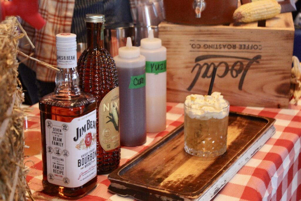 a table topped with bottles of alcohol and a tray of food