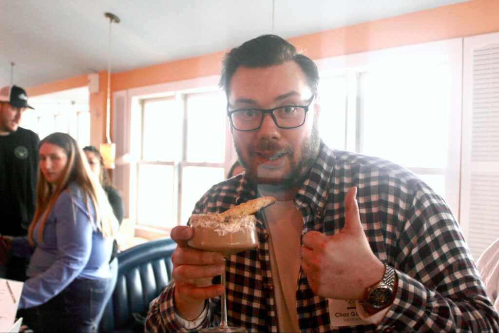 a man sitting at a table with a plate of food in front of him